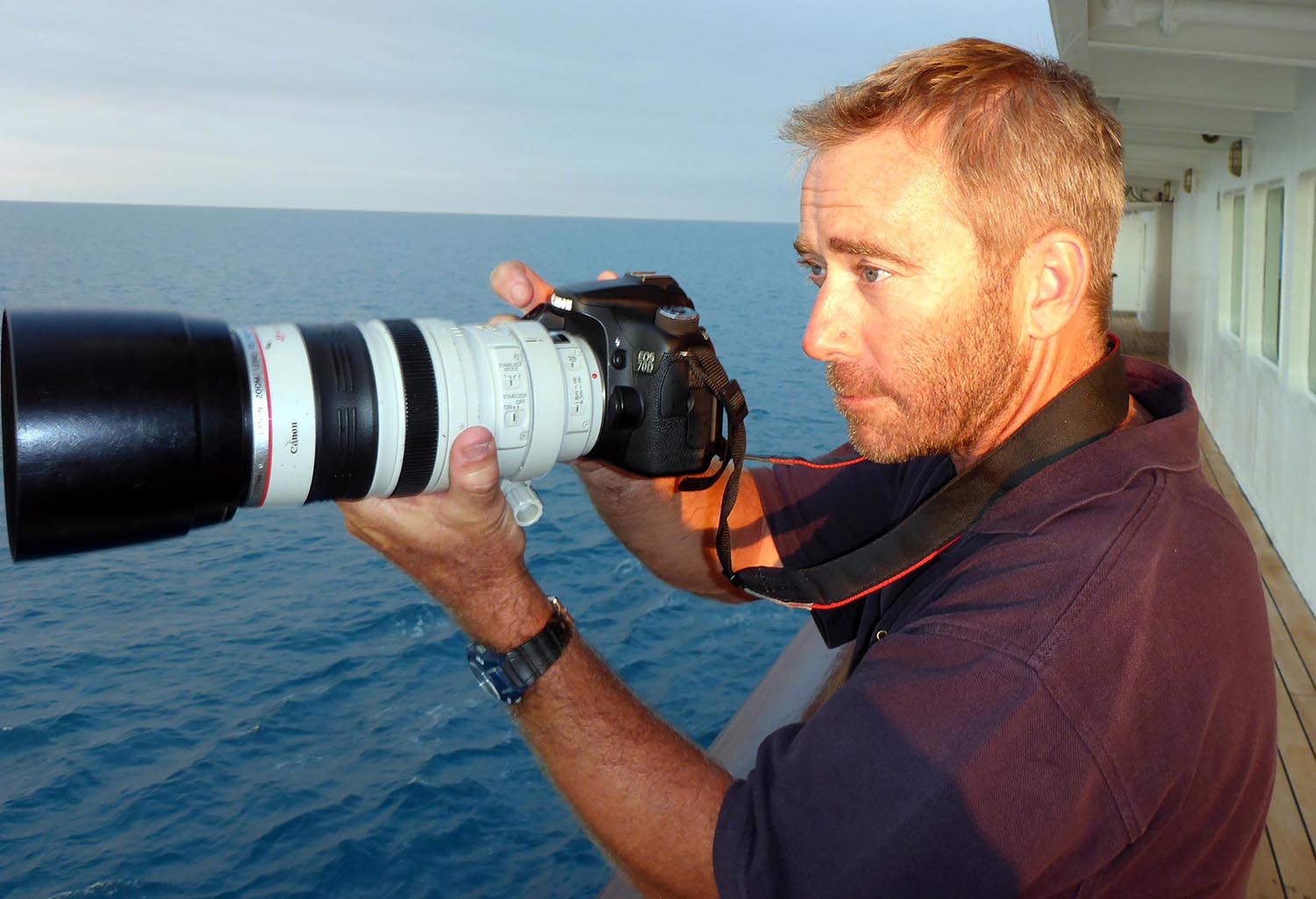 Damon Ramsey portrait on a ship, with a camera