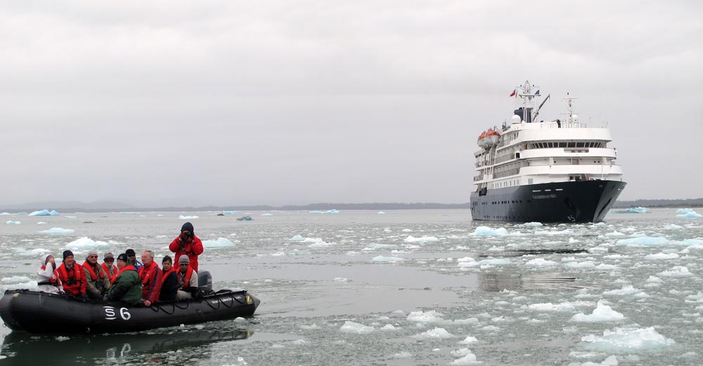expedition ship and zodiac in the ice, image by Damon Ramsey.